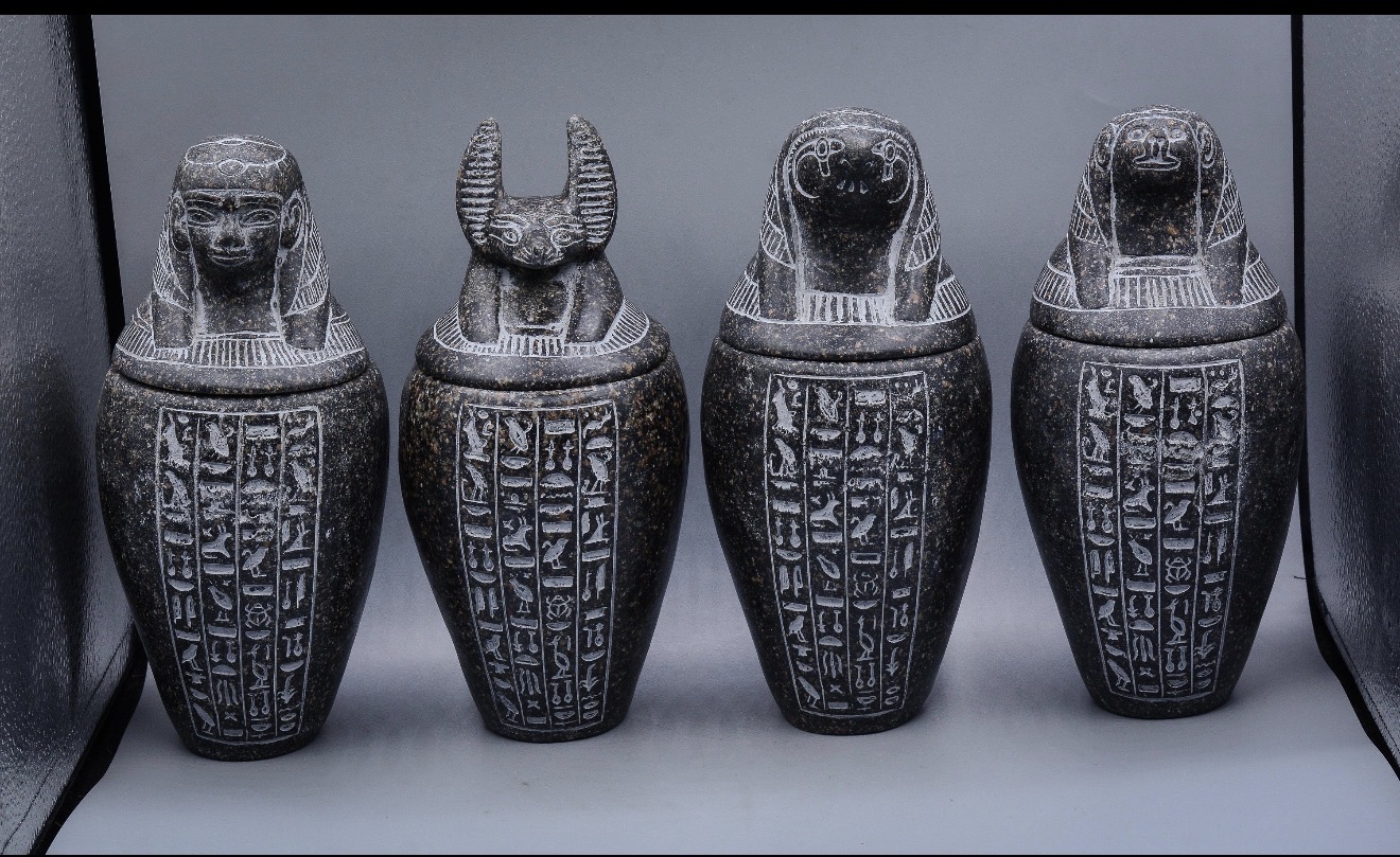 Canopic Jars — Ancient Egyptian sacred vessels housing the organs of the deceased, guarded by the Four Sons of Horus.